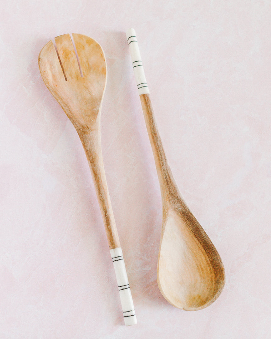 Striped Salad Servers Artisan olive wood salad servers featuring bold striped batiked cow bone handles on a natural wood grain finish