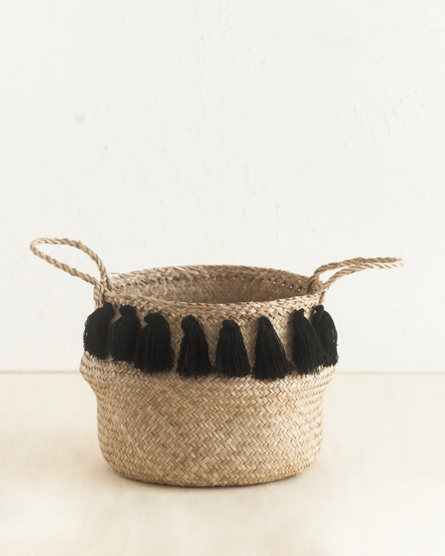 Artisan-crafted basket with modern tassels for living room décor