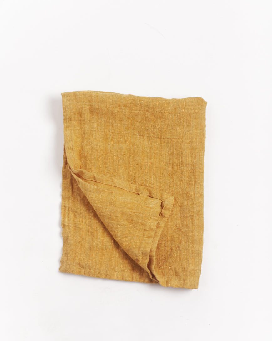 Stone Washed Linen Tea Towel Gold-Stone-washed linen towel casually draped on a white background, highlighting relaxed finish.