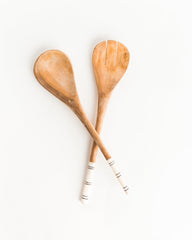 Hand-carved striped salad servers made from olive wood with batiked cow bone handles, ethically crafted in Kenya